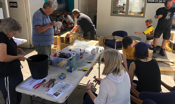 The community helping build wooden trapping tunnels