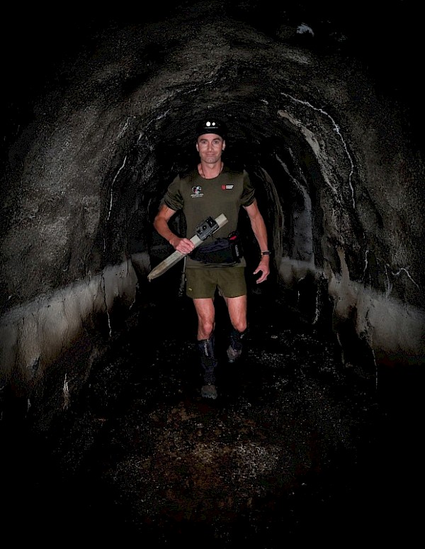 Tim installing a rat-detection camera in a tunnel in Miramar. Complex urban landscapes like these make predator elimination challenging and innovative. Photo – Tim Sutton